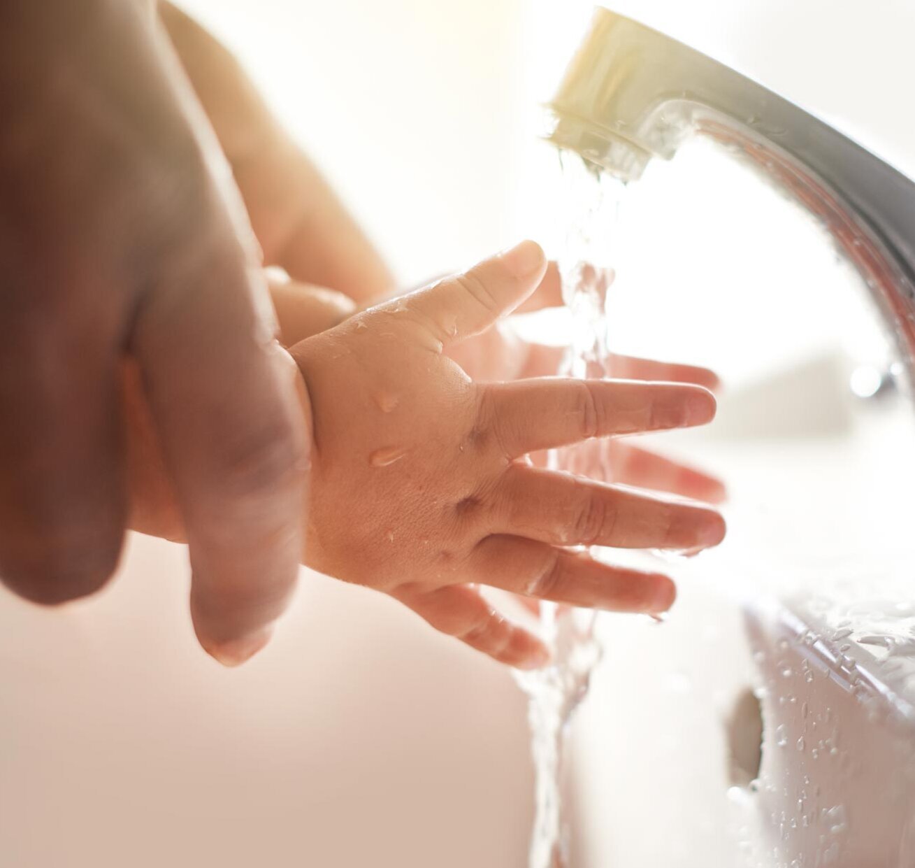Water flows through children's hands Water flows through children's hands