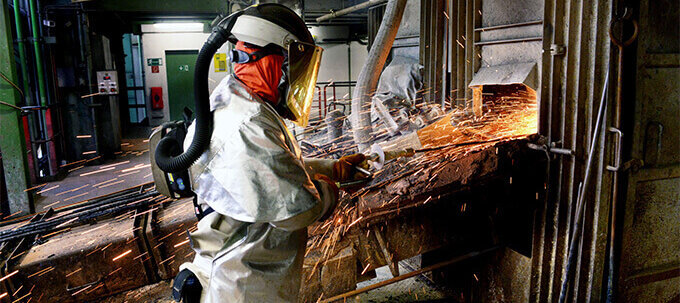 A worker wearing full-body personal protective equipment A worker wearing full-body personal protective equipment