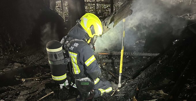 Feuerwehrmann trägt auch nach gelöschtem Brand umluftunabhängigen Atemschutz und Schutzkleidung. Feuerwehrmann trägt auch nach gelöschtem Brand umluftunabhängigen Atemschutz und Schutzkleidung zum Schutz vor Feuerkrebs.