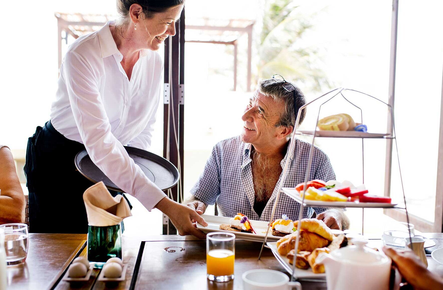 A friendly waitress serves a diner A friendly waitress serves a diner